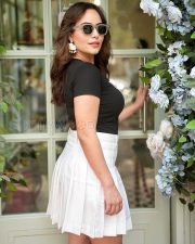 Actress Aanchal Munjal in a Hottie Tshirt and White Mini Skirt Photos 02