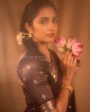 Charming Actress Rukmini Vasanth in a Retro Purple and Orange Outfit with a Pink Lotus Photos 01