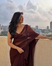 Big Beauty Nikita Sharma in a Maroon Saree with Sleeveless Blouse Photos 02