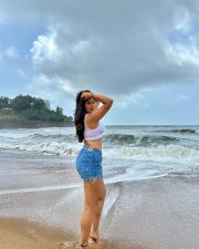 Erotic Model Nikita Sharma in a White Calvin Klein Sports Bra and Blue Denim Shorts Photos 01