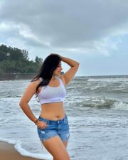 Erotic Model Nikita Sharma in a White Calvin Klein Sports Bra and Blue Denim Shorts Photos 02