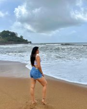 Erotic Model Nikita Sharma in a White Calvin Klein Sports Bra and Blue Denim Shorts Photos 03
