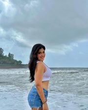 Erotic Model Nikita Sharma in a White Calvin Klein Sports Bra and Blue Denim Shorts Photos 04