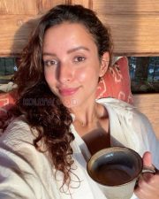 Spirited Actress Tripti Dimri in a White Linen Shirt Grey Cap Sunglasses Photos 01