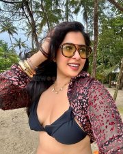 Stylish Indian Television Actress Nikita Sharma in a Black Bikini Top with a Sheer Cover Up Top and High Waisted Flare Pants Photos 03