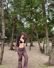 Stylish Indian Television Actress Nikita Sharma in a Black Bikini Top with a Sheer Cover Up Top and High Waisted Flare Pants Photos 04