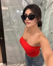 Alluring Actress Yesha Sagar in a Red Tube Top and Blue Jeans Photos 03