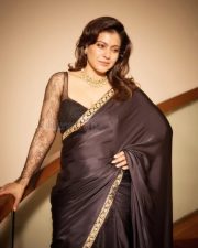 Maharagni Queen of Queens Actress Kajol Devgan in a Black Satin Saree with a Sheer Full Sleeved Lace Blouse Photos 01