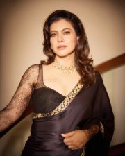 Maharagni Queen of Queens Actress Kajol Devgan in a Black Satin Saree with a Sheer Full Sleeved Lace Blouse Photos 02