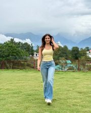 Radiant Actress Yesha Sagar in a Yellow ribbed tank top and blue jeans Photos 02