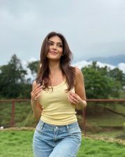 Radiant Actress Yesha Sagar in a Yellow ribbed tank top and blue jeans Photos 04