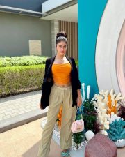 Sexy Shobhita Rana in an Orange Crop Top Black Jacket and Beige Pant Pictures 03