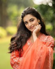 Seyon Movie Heroie Bhagyashree Borse in a Vibrant Orange Anarkali Suit with White Floral Embroidery Photos 04