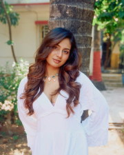 Enchanting Actress Srushti Bannatti in a White Ruffled Deep V Dress Photos 04