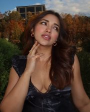 Sexy Jiya Shankar in a Black Satin Sleeveless Bustier Top with a Lace V Neckline and Light Blue Jeans Photos 01