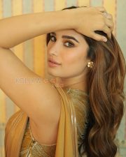 Opulent Actress Rasha Thadani in a Metallic Gold Draped Saree with Ribbed Halterneck Blouse Photos 05