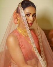 SOS Kolkata Actress Mimi Chakraborty in a Coral Orange Sleeveless Silk Crop Blouse and a Matching Lehenga Skirt with Sheer Net Dupatta Pictures 04