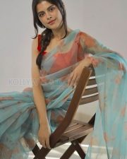 Actress Sanjana Krishnamoorthy in a Floral Saree with a Red Sleeveless Blouse Photos 03