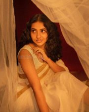 Beautiful Mamitha Baiju in a White Transparent Saree with Gold Border and Sleeveless Blouse Photos 02