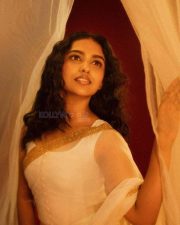 Beautiful Mamitha Baiju in a White Transparent Saree with Gold Border and Sleeveless Blouse Photos 04
