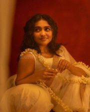 Beautiful Mamitha Baiju in a White Transparent Saree with Gold Border and Sleeveless Blouse Photos 05