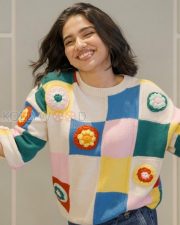 Delightful Actress Mamitha Baiju in a Colorful Crochet Sweater and Blue Jeans Photos 01