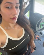 Confident Actress Dhanashree Verma in a Black Sports Bra and Cap Photos 02