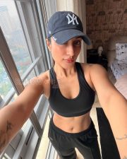 Confident Actress Dhanashree Verma in a Black Sports Bra and Cap Photos 03