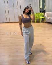 Confident Actress Dhanashree Verma in a Black Sports Bra and Cap Photos 04