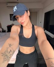 Confident Actress Dhanashree Verma in a Black Sports Bra and Cap Photos 05