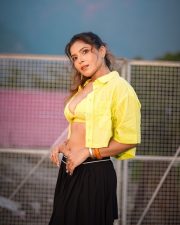 Passionate Actress and Model Tanya Chaudhari in a Yellow Bralette Crop Top and a Black Pleated Mini Skirt Pictures 03