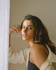 Elegant Actress Vishnu Priya Bhimeneni in a cream linen button up shirt and black bra top photos 02