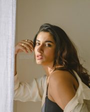 Elegant Actress Vishnu Priya Bhimeneni in a cream linen button up shirt and black bra top photos 02