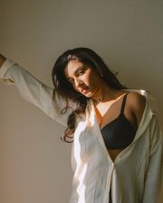 Elegant Actress Vishnu Priya Bhimeneni in a cream linen button up shirt and black bra top photos 04