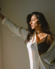 Elegant Actress Vishnu Priya Bhimeneni in a cream linen button up shirt and black bra top photos 05