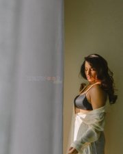 Elegant Actress Vishnu Priya Bhimeneni in a cream linen button up shirt and black bra top photos 06