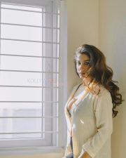 Elegant Actress Vishnu Priya Bhimeneni in a cream linen button up shirt and black bra top photos 07