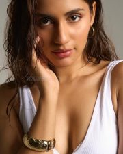 Polished Actress Anushka Luhar in a white ribbed sleeveless tank top with gold metallic bracelet photos 04