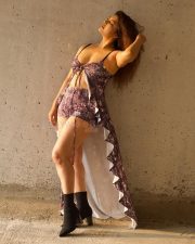 Provocative Actress Poonam Rajput in a Purple and White Sleeveless Halter Neck Top with Cleavage Neckline with Matching Micro Shorts Pictures 01