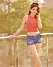 Stylish Actress Aarna Vohra in a Coral Knit Crop Top and Denim Shorts Photos 07