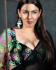 Glamorous Actress Yamini Malhotra in a black V neck crop top with drop earrings photos 02