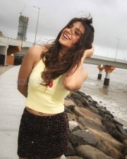 Radiant Actress Natasha Bharadwaj in a Yellow Crop Top and Sequin Shorts Photos 06