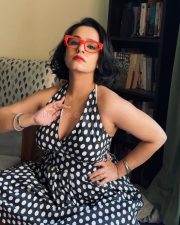 Winsome Apoorva Arora Cleavage in a Black And White Polka Dot Halter Wrap Dress Photos 03
