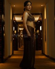 Intriguing Singer Neeti Mohan in a Metallic Bronze Sequined Bralette Style Top with a Brown Floor Length Skirt Pictures 09