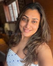 Natural Actress Malavika in a White Printed Sleeveless Top Photos 01