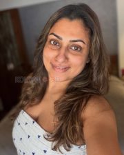 Natural Actress Malavika in a White Printed Sleeveless Top Photos 03